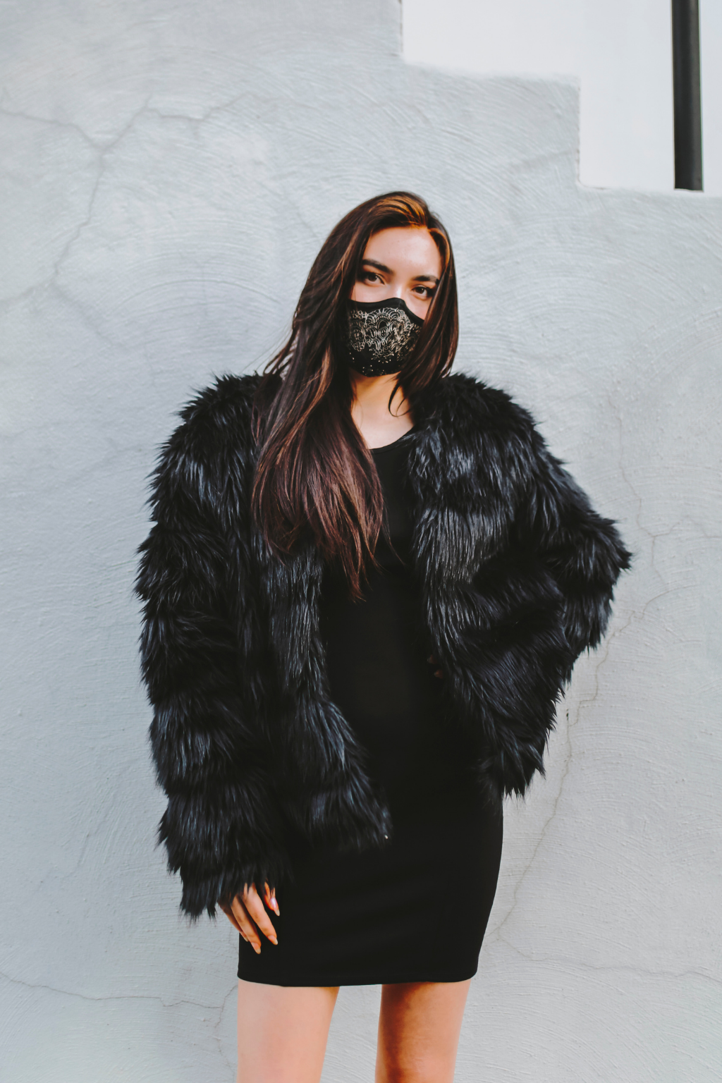 Woman wearing black/gold lace mask