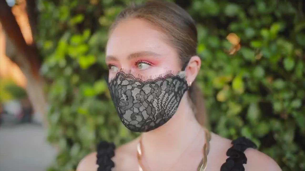 Woman wearing black eyelash face mask
